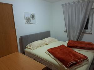 a small bedroom with a bed and a window at Vikendica Vlahić, Goranci in Mostar