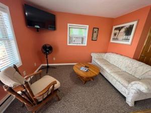 a living room with a couch and a table at Lakin' It Easy in Middlebury