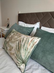 a bed with green pillows at Casa do Alfaiate - Douro in Peso da Régua