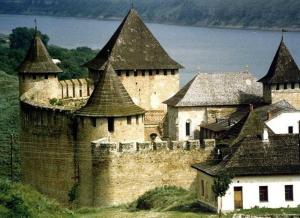 a large castle with some buildings and a body of water at Dnister Hotel Complex in Zhvanets