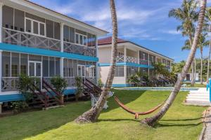 a house with a hammock in front of it at Cosy apartments las terrenas in Las Terrenas