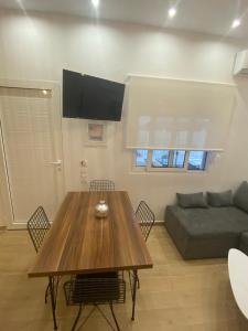 a living room with a wooden table and a couch at Little Home in Potos