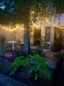 a patio with a table and a tree with lights at foodiejive appartement 2 in Antwerp