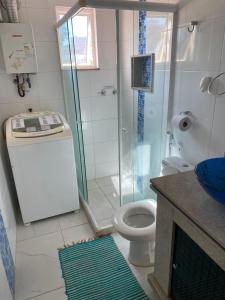 a bathroom with a shower and a toilet and a sink at Fioravante's Apartment in Rio de Janeiro