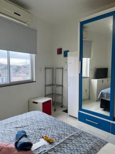 a bedroom with a bed and a large mirror at Fioravante's Apartment in Rio de Janeiro