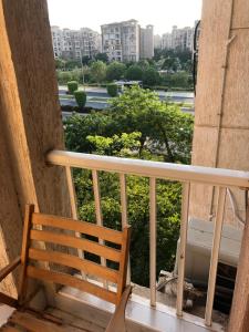 a balcony with a bench and a view of a city at شقه مفروشه ومكيفه بمدينتي Madinaty B7-families& married only in Madinaty