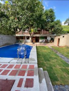 a house with a swimming pool in a yard at Cabaña Casa Lila in Santa Marta