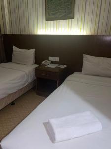 Llit o llits en una habitació de Hotel DarulMakmur Jerantut