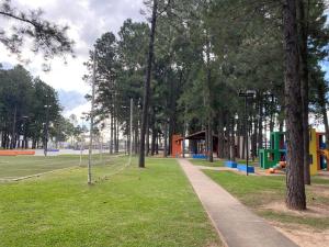 a park with a path and trees and a playground at Casa Pinatar en condominio in Santa Cruz de la Sierra