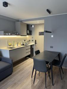 a kitchen and dining room with a table and chairs at One Manquehue Aparthotel in Santiago