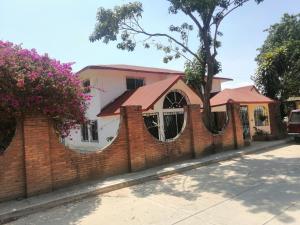 a brick fence in front of a house at Casa Las Animas in El Carmen