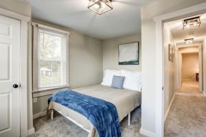 a bedroom with a bed with a blue blanket on it at Beautiful Farmhouse close to Lanc Hershey Etown in Mount Joy