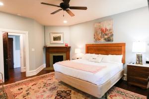 a bedroom with a large bed and a fireplace at Summit Street Inns in Winston-Salem
