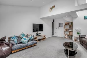 a living room with a couch and a tv at Lparking Sleep7 4br 2 Ba in Horsford
