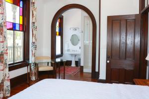 um quarto com uma cama, um espelho e uma porta em Summit Street Inns em Winston-Salem