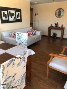 - un salon avec un canapé et une table dans l'établissement Gran departamento frente a la bahía de La Herradura, à Coquimbo