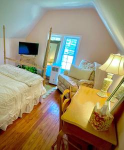 a bedroom with a bed and a table with a lamp at 9 Booth Lane in Haverford