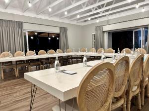 a conference room with a long table and chairs at Serene Place Guest House & Conference Venue AFFORDABLE LUXURY WITH BACKUP POWER in Roodepoort