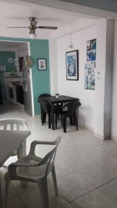 a dining room with a black table and chairs at Casa Amplia Completa Privada para Familias in Santa Marta