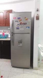 a refrigerator in a kitchen with magnets on it at Casa Amplia Completa Privada para Familias in Santa Marta