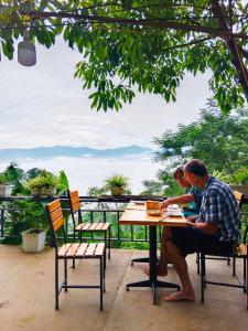 a couple of people sitting at a table at homestay phô núi suôi giang in Yên Bái