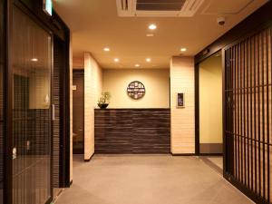 a hallway of a building with a door and a window at Waka Heian Shirakawa Hotel in Kyoto