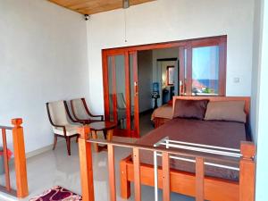 a bedroom with a bed and a table and a chair at Raweg Studio in Amed