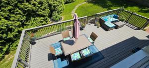 an overhead view of a deck with chairs and an umbrella at 1 Bed with Private Bathroom Close to Everything in Newark & Wilmington in Newark