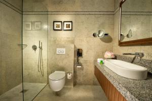 a bathroom with a toilet a sink and a bathtub at Best Western Premier Hotel Slon in Ljubljana
