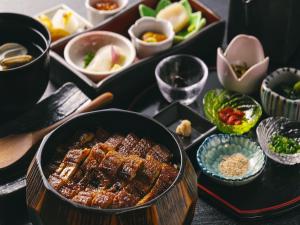 a table topped with plates of food and bowls of food at Hakodate Kokusai Hotel in Hakodate
