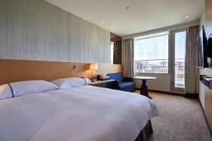 a hotel room with a large bed and a window at K Hotel Tianjin in Taipei