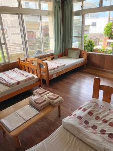 a room with three beds and a large window at フェーヌカジ洋室 in Miyako-jima