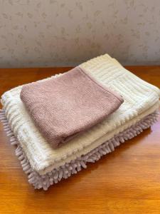 un asciugamano seduto sopra un tavolo di legno di フェーヌカジ洋室 a Miyakojima