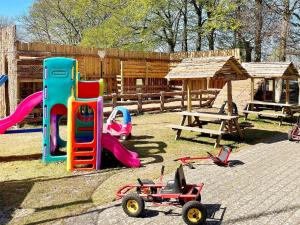 a playground with a slide and a table and play equipment at 5 star holiday home in Grindsted-By Traum in Grindsted
