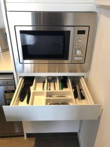 a microwave oven on a shelf in a kitchen at Serain Residences on 88 Archer Chatswood in Sydney