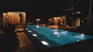 a large swimming pool at night with lights at Luxe Panoramic 3 Bedroom Penthouse with onsite parking in Melbourne