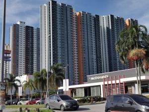 um parque de estacionamento com carros estacionados em frente a edifícios altos em klia alanis residence free wifi em Sepang