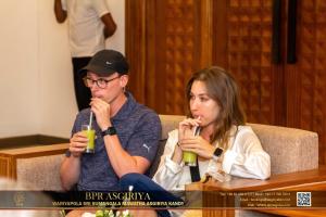 a man and woman sitting on a couch with drinks in their mouths at BPR - Asgiriya ,Kandy in Kandy