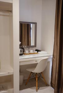a desk with a mirror and a chair in a room at LeBlanc Hotel in Antipolo