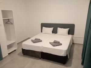 a bedroom with a bed with two towels on it at BluejSuite in Ayia Napa
