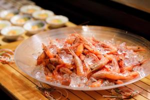 a bowl of food with shrimp on a table at Hotel Nikko Kanazawa in Kanazawa