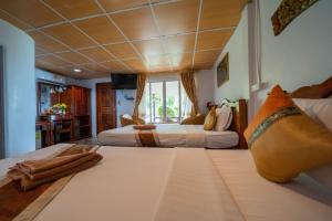 Voodi või voodid majutusasutuse Tongta Phaview Resort toas