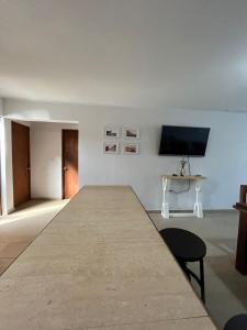 a large table in a room with a flat screen tv at Casa con vista al mar! in Tomé