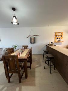 a dining room with a wooden table and chairs at Casa con vista al mar! in Tomé