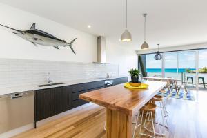 a kitchen with a shark painting on the wall at On The Beach in Lorne