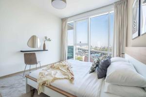a bedroom with a bed with a large window at ALFA World Trade Centre Dubai 1BR, MAX Metro Station in Dubai