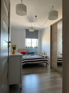 a bedroom with a bed in the middle of a room at Apartament 20 in Radków
