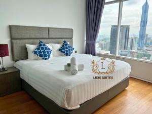 a bedroom with a large bed with a large window at Luxe Suites at Vortex KLCC in Kuala Lumpur +31 photos