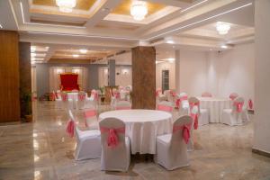 a banquet hall with white tables and pink chairs at Regenta Place Sabrina Kathmandu Nepal in Kathmandu