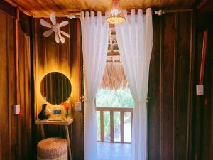 a room with a window with white curtains and a mirror at Lagom Bắc Hà Farmstay in Lao Cai +291 photos